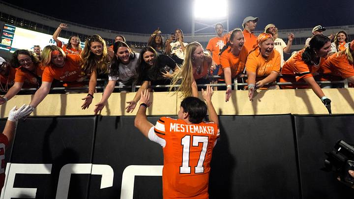 Oklahoma State 's Drew Mestemaker high fives fans following a game. Oklahoma State 's Drew Mestemaker high fives fans following a game.