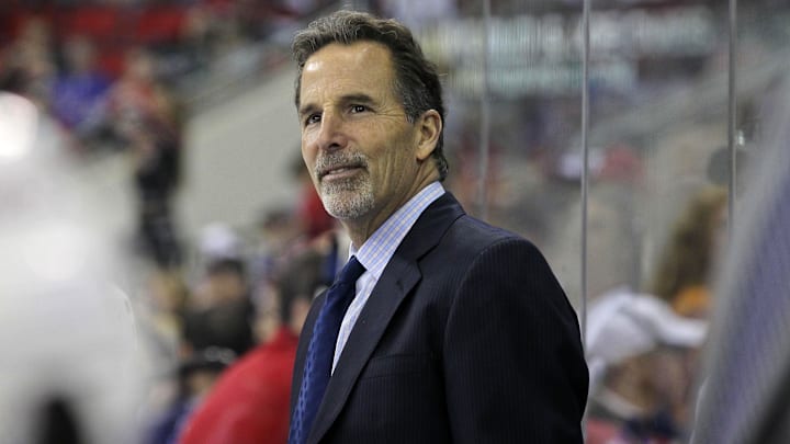 March 1, 2012; Raleigh, NC, USA; New York Rangers coach John Tortorella smiles during the game against the Carolina Hurricanes at the RBC center. The Rangers defeated the Hurricanes, 3-2. Mandatory Credit: James Guillory-Imagn Images