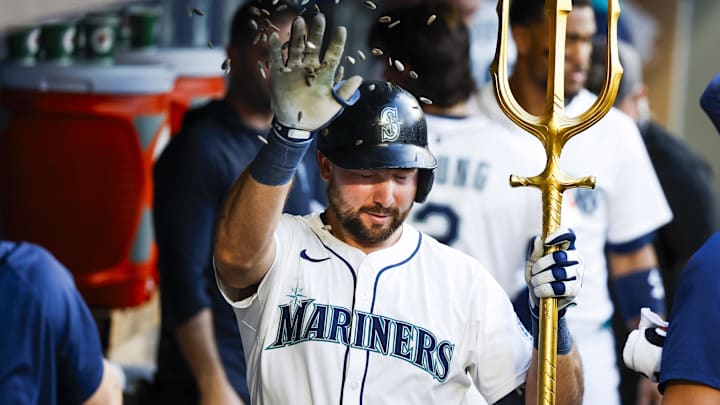 Seattle Mariners catcher Cal Raleigh celebrates in the dugout after hitting a home run against the Kansas City Royals on June 30 at T-Mobile Park.