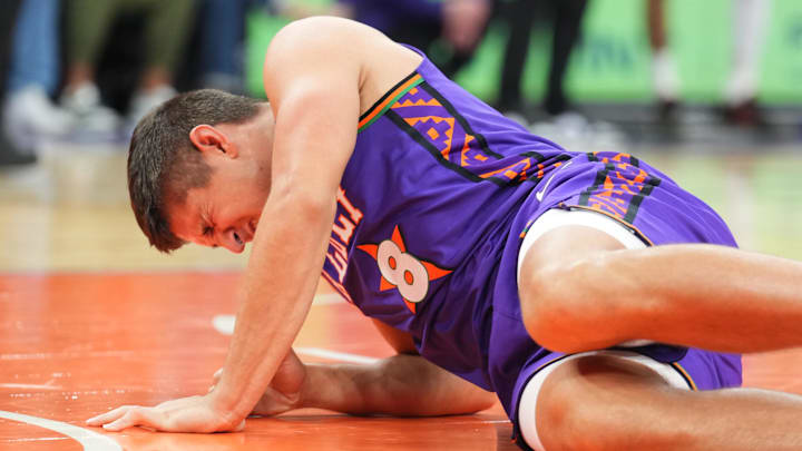 Dec 21, 2024; Phoenix, Arizona, USA; Phoenix Suns guard Grayson Allen (8) reacts after being injured against the Detroit Pistons during the second half at Footprint Center. Mandatory Credit: Joe Camporeale-Imagn Images