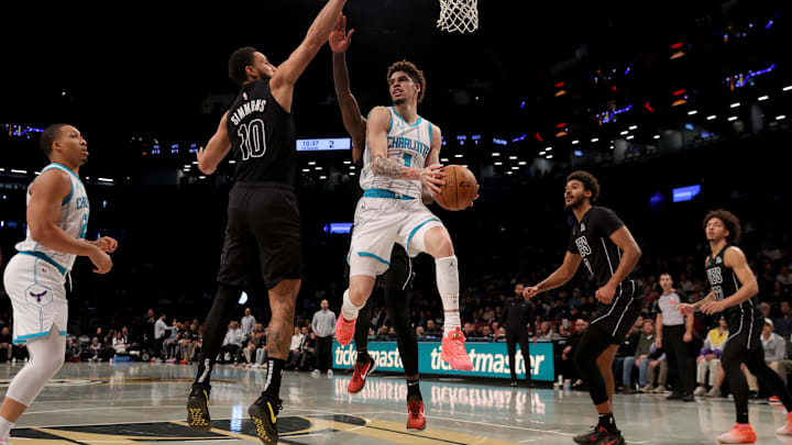 Nov 19, 2024; Brooklyn, New York, USA; Charlotte Hornets guard LaMelo Ball (1) looks to pass the ball against Brooklyn Nets guard Ben Simmons (10) and forwards Dorian Finney-Smith (28) and Cameron Johnson (2) during the first quarter at Barclays Center. Mandatory Credit: Brad Penner-Imagn Images Nov 19, 2024; Brooklyn, New York, USA; Charlotte Hornets guard LaMelo Ball (1) looks to pass the ball against Brooklyn Nets guard Ben Simmons (10) and forwards Dorian Finney-Smith (28) and Cameron Johnson (2) during the first quarter at Barclays Center. Mandatory Credit: Brad Penner-Imagn Images