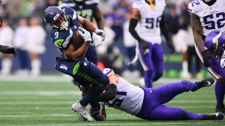Dec 22, 2024; Seattle, Washington, USA; Seattle Seahawks running back Kenneth Walker III (9) stretches for extra yards during a run play against the Minnesota Vikings in the second half at Lumen Field.