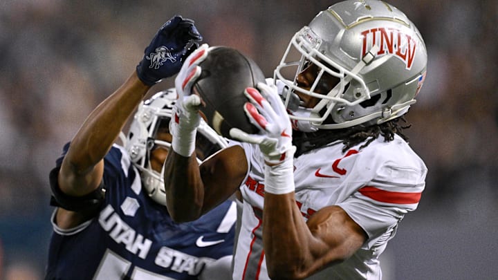 UNLV Rebels wide receiver Ricky White III (11) catches a touchdown pass in front of Utah State Aggies cornerback Avante Dickerson (17) in the first half at Merlin Olsen Field at Maverik Stadium. Mandatory Credit: Jamie Sabau-Imagn Images