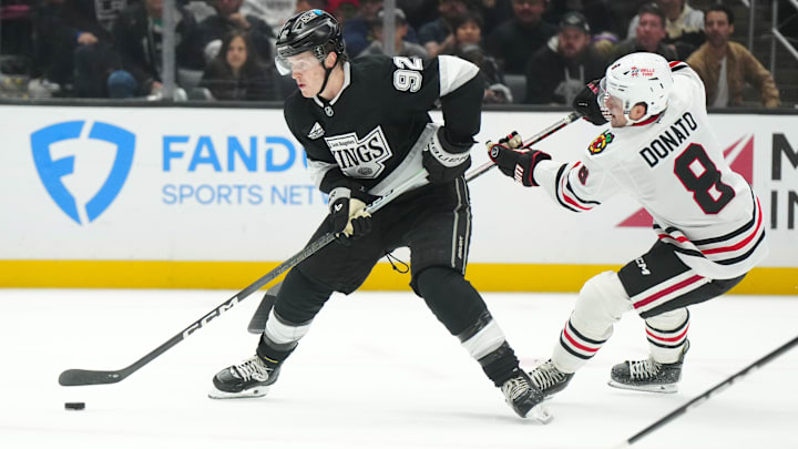 Nov 2, 2024; Los Angeles, California, USA; LA Kings defenseman Brandt Clarke (92) skates with the puck against Chicago Blackhawks center Ryan Donato (8) in the third period at Crypto.com Arena. Mandatory Credit: Kirby Lee-Imagn Images