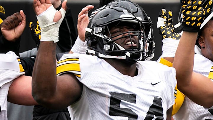 Iowa defensive linemen Anterio Thompson (54), Jackson Filer (33) and Caden Crawford (97) wave to patients in the Stead Family Children's Hospital wave during the Hawkeyes' final spring NCAA football practice, Saturday, April 22, 2023, at Kinnick Stadium in Iowa City, Iowa.

230422 Iowa Spring Fb 075 Jpg