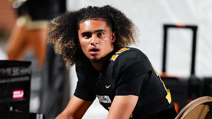 Oct 20, 2023; Carrollton, GA, USA; Carrollton Trojans quarterback Julian Lewis (10) watches on from the sidelines against the Westlake Lions during the first half at Grisham Stadium. The 15-year-old Carrollton High student has already committed to playing for the University of Southern California Trojans and has been considered one of the top high school quarterback prospects.