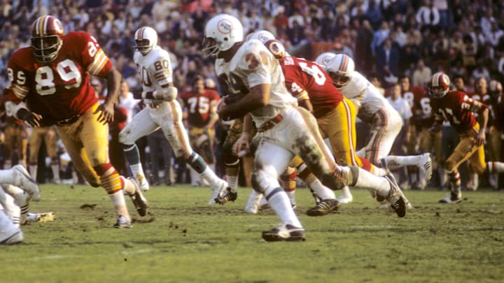 Miami Dolphins running back Larry Csonka (39) runs the ball chased by Washington Redskins defensive end Verlon Biggs (89) during Super Bowl VII at the Los Angeles Memorial Coliseum. The Dolphins would defeat the Redskins 14-7. Miami Dolphins running back Larry Csonka (39) runs the ball chased by Washington Redskins defensive end Verlon Biggs (89) during Super Bowl VII at the Los Angeles Memorial Coliseum. The Dolphins would defeat the Redskins 14-7.
