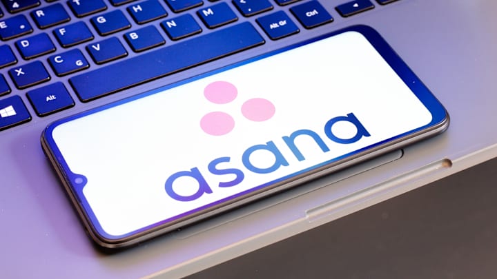 In this photo illustration, the Asana logo is seen displayed...