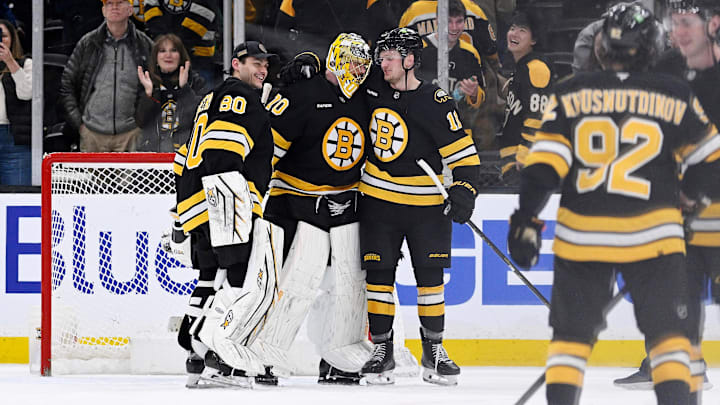 Feb 26, 2026; Boston, Massachusetts, USA; Boston Bruins goaltender Joonas Korpisalo (70) celebrates defeating the Columbus Blue Jackets with goaltender Michael DiPietro (80) and center Casey Mittelstadt (11) at TD Garden. Mandatory Credit: Eric Canha-Imagn Images