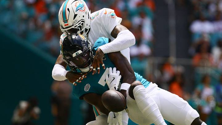 Miami Dolphins cornerback Jalen Ramsey (5) fouls Jacksonville Jaguars wide receiver Brian Thomas Jr. (7) during the first quarter at Hard Rock Stadium in the 2024 season opener.