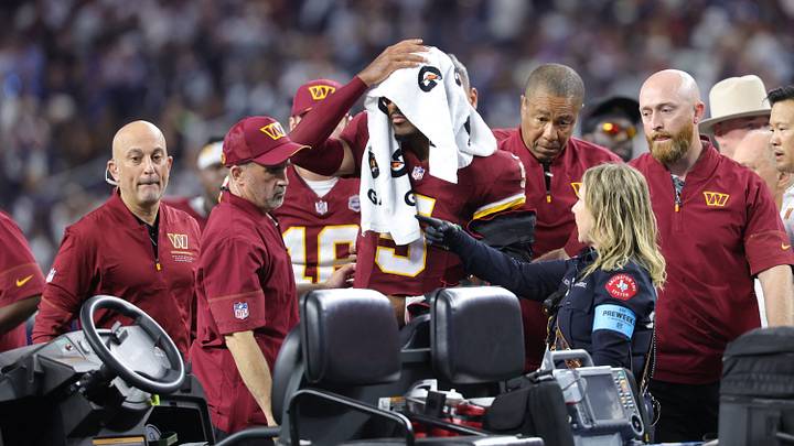 Sep 20, 2026; Arlington, Texas, USA; Washington Commanders quarterback Jayden Daniels (5) gets into a cart with a towel over his head before leaving the game with an apparent injury to his left arm during the second half against the Dallas Cowboys at AT&T Stadium. Mandatory Credit: Kevin Jairaj-Imagn Images Sep 20, 2026; Arlington, Texas, USA; Washington Commanders quarterback Jayden Daniels (5) gets into a cart with a towel over his head before leaving the game with an apparent injury to his left arm during the second half against the Dallas Cowboys at AT&T Stadium. Mandatory Credit: Kevin Jairaj-Imagn Images