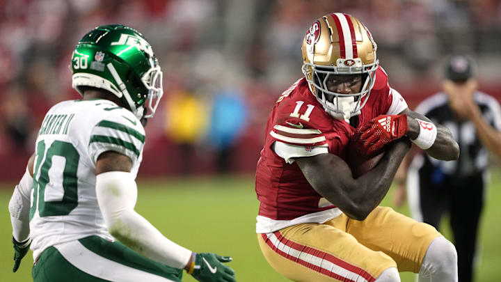 Sep 9, 2024; Santa Clara, California, USA; San Francisco 49ers wide receiver Brandon Aiyuk (11) runs after a catch against New York Jets cornerback Michael Carter II (left) during the fourth quarter at Levi's Stadium. Mandatory Credit: Darren Yamashita-Imagn Images Sep 9, 2024; Santa Clara, California, USA; San Francisco 49ers wide receiver Brandon Aiyuk (11) runs after a catch against New York Jets cornerback Michael Carter II (left) during the fourth quarter at Levi's Stadium. Mandatory Credit: Darren Yamashita-Imagn Images