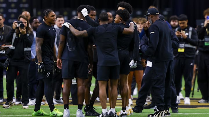 Apr 4, 2025; Boulder, CO, USA; Colorado Buffaloes participating in the University of Colorado NFL Showcase huddle up before running drills at the CU Indoor Practice Facility. 