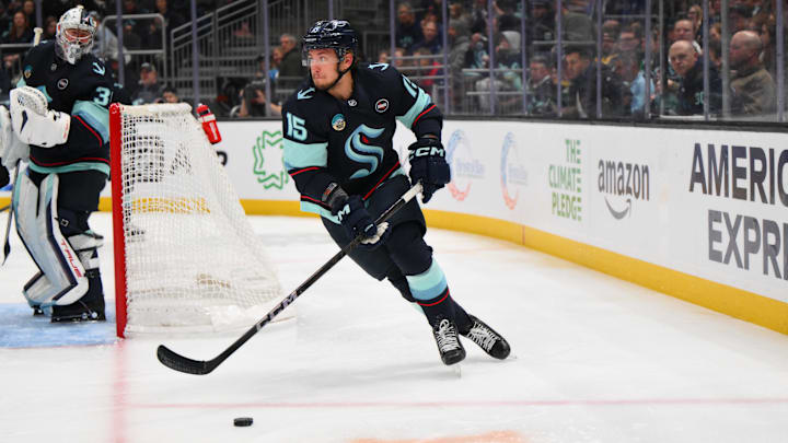Mar 31, 2025; Seattle, Washington, USA; Seattle Kraken center John Hayden (15) plays the puck during the third period against the Dallas Stars at Climate Pledge Arena. Mandatory Credit: Steven Bisig-Imagn Images