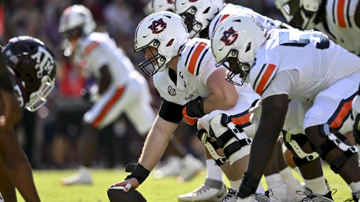 Sep 27, 2025; College Station, Texas, USA; Auburn Tigers offensive lineman Connor Lew (75) sets the ball against the Texas A&M Aggies at Kyle Field. Mandatory Credit: Maria Lysaker-Imagn Images 