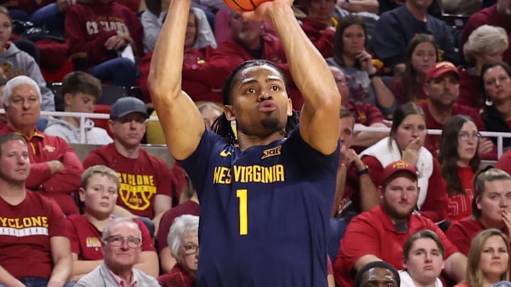 Jan 2, 2026; Ames, Iowa, USA; West Virginia Mountaineers guard Jasper Floyd (1) shoots against the Iowa State Cyclones during the second half at James H. Hilton Coliseum. Mandatory Credit: Reese Strickland-Imagn Images