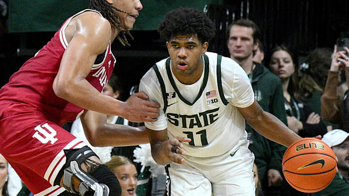 Feb 11, 2025; East Lansing, Michigan, USA;  Michigan State Spartans guard Jase Richardson (11) drives past Indiana Hoosiers forward Malik Reneau (5) during the second half at Jack Breslin Student Events Center. Mandatory Credit: Dale Young-Imagn Images