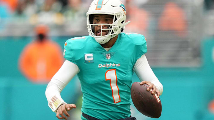Dec 25, 2022; Miami Gardens, Florida, USA; Miami Dolphins quarterback Tua Tagovailoa (1) scrambles