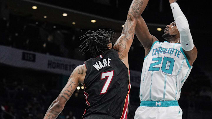 Oct 8, 2024; Charlotte, North Carolina, USA; Charlotte Hornets forward Harry Giles III (20) shoots over Miami Heat center Kel'el Ware (7) during the second half at Spectrum Center. Mandatory Credit: Jim Dedmon-Imagn Images