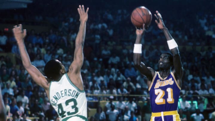 Jun 1984; Boston, MA, USA; FILE PHOTO; Los Angeles Lakers guard Michael Cooper (21) takes a shot over Boston Celtics guard Gerald Henderson (43) during the 1984 NBA Finals at the Boston Garden. The Celtics defeated the Lakers 4 games to 3. Mandatory Credit: Dick Raphael-Imagn Images