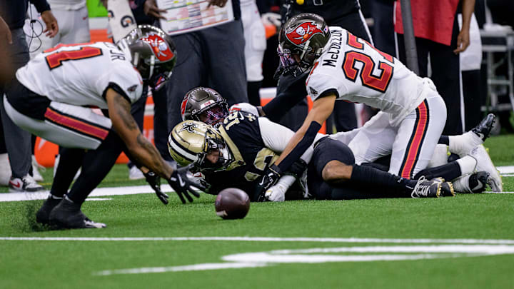 Oct 13, 2024; New Orleans, Louisiana, USA; Tampa Bay Buccaneers safety Antoine Winfield Jr. (31) picks up a ball after it was striped from New Orleans Saints wide receiver Chris Olave (12) during the first quarter at Caesars Superdome. Mandatory Credit: Matthew Hinton-Imagn Images Oct 13, 2024; New Orleans, Louisiana, USA; Tampa Bay Buccaneers safety Antoine Winfield Jr. (31) picks up a ball after it was striped from New Orleans Saints wide receiver Chris Olave (12) during the first quarter at Caesars Superdome. Mandatory Credit: Matthew Hinton-Imagn Images
