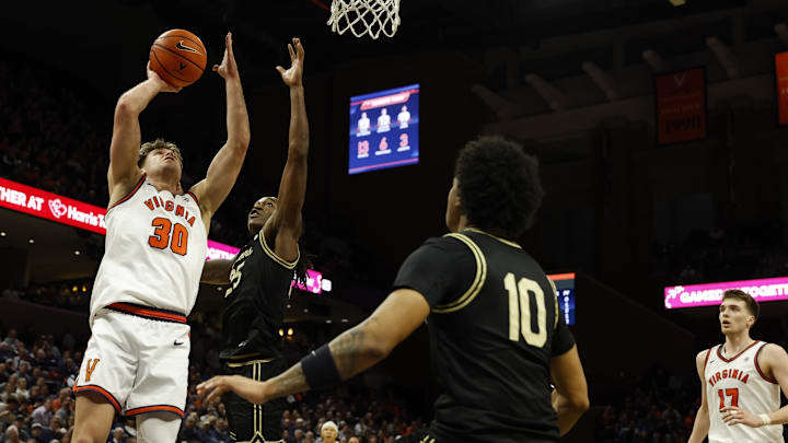 Virginia Cavaliers guard Dallin Hall and Wake Forest Demon Deacons forward Tre'von Spillers 