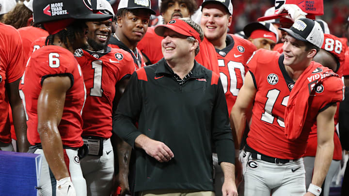 Dec 3, 2022; Atlanta, GA, USA; Georgia Bulldogs running back Kenny McIntosh (6), head coach Kirby Smart, and quarterback Stetson Bennett (13) celebrate after a victory in the SEC Championship against the LSU Tigers at Mercedes-Benz Stadium. Mandatory Credit: Brett Davis-Imagn Images