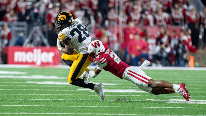 Oct 11, 2025; Madison, Wisconsin, USA; Iowa Hawkeyes running back Kamari Moulton (28) is tackled by Wisconsin Badgers cornerback Cairo Skanes (21) in the second half at Camp Randall Stadium. Mandatory Credit: Ross Harried-Imagn Images Oct 11, 2025; Madison, Wisconsin, USA; Iowa Hawkeyes running back Kamari Moulton (28) is tackled by Wisconsin Badgers cornerback Cairo Skanes (21) in the second half at Camp Randall Stadium. Mandatory Credit: Ross Harried-Imagn Images