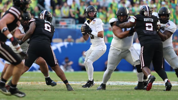 Oregon Ducks quarterback Dante Moore (5) stands in the pocket against the Texas Tech Red Raiders during the second half of the 2025 Orange Bowl