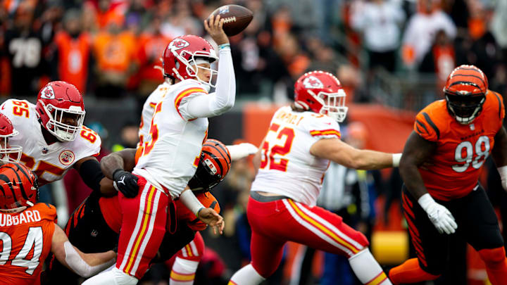 Kansas City Chiefs quarterback Patrick Mahomes (15) completes a pass as he's hit throwing by Kansas City Chiefs guard Trey Smith (65) in the first half of the NFL game between the Cincinnati Bengals and the Kansas City Chiefs on Sunday, Jan. 2, 2022, at Paul Brown Stadium in Cincinnati.

Cincinnati Bengals And The Kansas City Chiefs 457