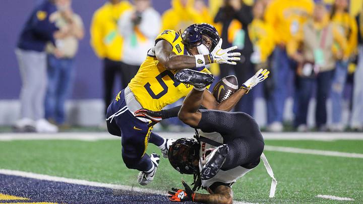 Sep 26, 2026; Morgantown, West Virginia, USA;  West Virginia Mountaineers wide receiver Jaden Bray (5) and Oklahoma State Cowboys cornerback LaDainian Fields (9) collide at the goal line for a pass attempt during the fourth quarter at Milan Puskar Stadium.  Mandatory Credit: Ben Queen-Imagn Images