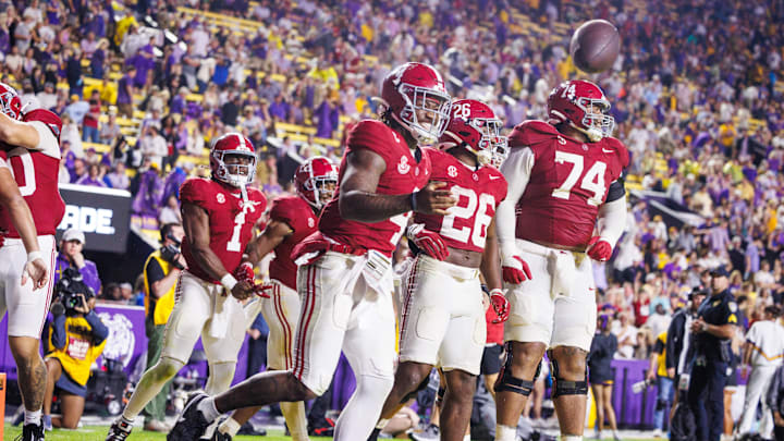 Nov 9, 2024; Baton Rouge, Louisiana, USA;  Alabama Crimson Tide quarterback Jalen Milroe (4) tosses the football to the referee after scoring a touchdown against the LSU Tigers during the second half at Tiger Stadium. Mandatory Credit: Stephen Lew-Imagn Images