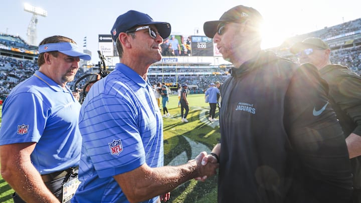 Nov 16, 2025; Jacksonville, Florida, USA; Los Angeles Chargers head coach Jim Harbaugh, left, shakes hands with Jacksonville Jaguars head coach Liam Coen following a Jaguars victory at EverBank Stadium. Mandatory Credit: Nathan Ray Seebeck-Imagn Images Nov 16, 2025; Jacksonville, Florida, USA; Los Angeles Chargers head coach Jim Harbaugh, left, shakes hands with Jacksonville Jaguars head coach Liam Coen following a Jaguars victory at EverBank Stadium. Mandatory Credit: Nathan Ray Seebeck-Imagn Images
