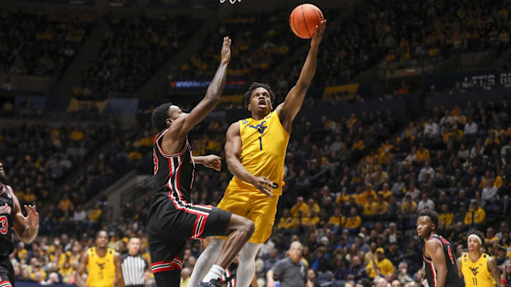 Jan 29, 2025; Morgantown, West Virginia, USA; West Virginia Mountaineers guard Joseph Yesufu (1) shoots against Houston Cougars guard Terrance Arceneaux (23) during the first half at WVU Coliseum. Mandatory Credit: Ben Queen-Imagn Images