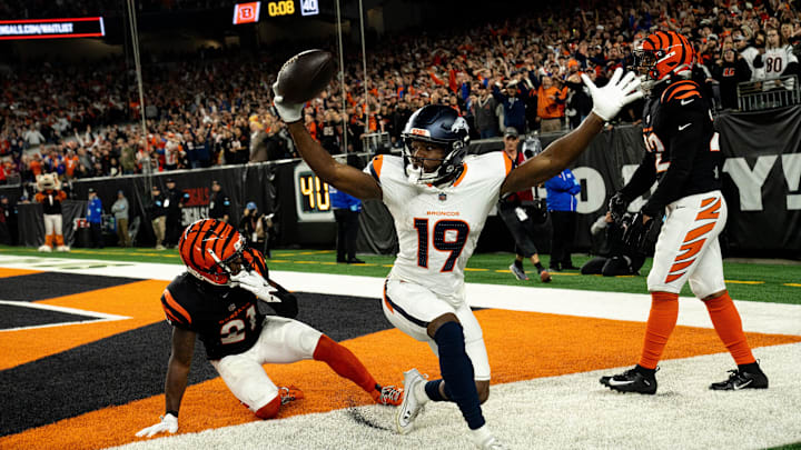 Broncos wide receiver Marvin Mims Jr. (19) reacts to scoring a touchdown as Bengals cornerback Mike Hilton (21) and safety Geno Stone (22) look on with eight seconds left in the fourth quarter at Paycor Stadium on Saturday, Dec. 28, 2024.