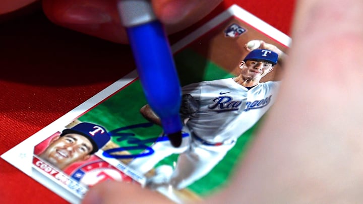 Left-handed pitcher Cody Bradford signs a baseball card for a fan during the Texas Rangers Winter Caravan stop at Lithia Toyota Wednesday Jan. 31, 2024. Left-handed pitcher Cody Bradford signs a baseball card for a fan during the Texas Rangers Winter Caravan stop at Lithia Toyota Wednesday Jan. 31, 2024.