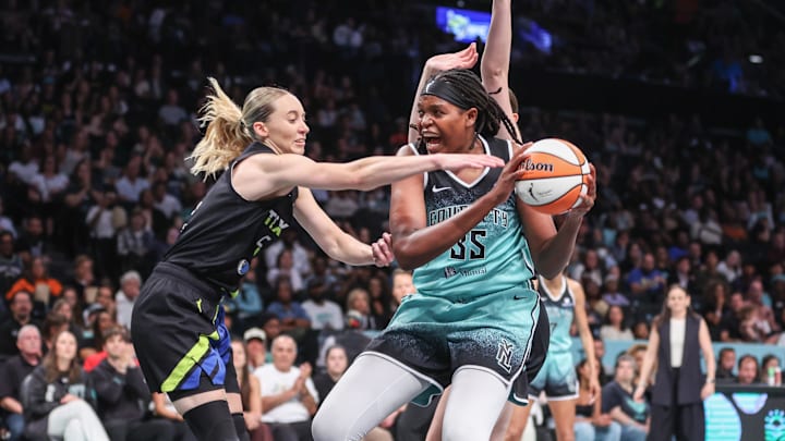 Aug 5, 2025; Brooklyn, New York, USA;  Dallas Wings guard Paige Bueckers (5) and New York Liberty center Jonquel Jones (35) fight for a loose ball in the third quarter at Barclays Center. Mandatory Credit: Wendell Cruz-Imagn Images