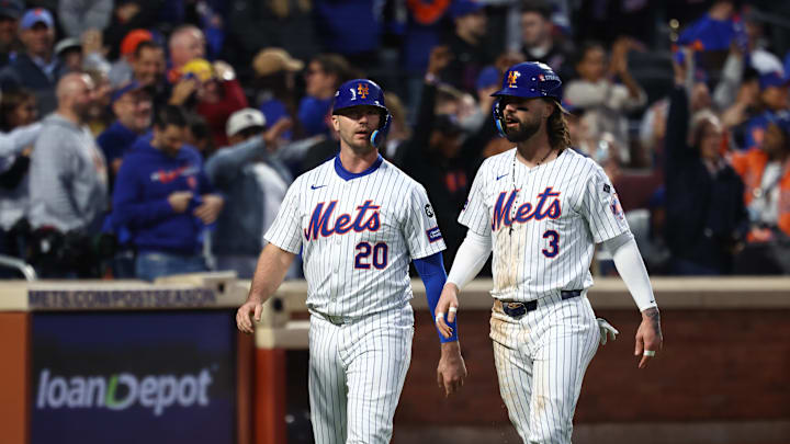 Oct 18, 2024; New York City, New York, USA; New York Mets first baseman Pete Alonso (20) and designated hitter Jesse Winker (3) walk back to the dugout after scoring during the third inning against the Los Angeles Dodgers during game five of the NLCS for the 2024 MLB playoffs at Citi Field. Mandatory Credit: Vincent Carchietta-Imagn Images