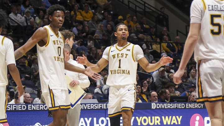 Jan 17, 2026; Morgantown, West Virginia, USA; West Virginia Mountaineers guard Jasper Floyd (1) celebrates with teammates during the first half against the Colorado Buffaloes at Hope Coliseum. Mandatory Credit: Ben Queen-Imagn Images
