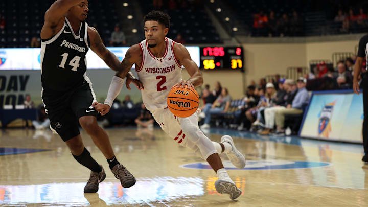 Nov 27, 2025; San Diego, CA, USA; Wisconsin Badgers guard Nick Boyd (2) drives the ball against Providence Friars guard Jr. Corey Floyd (14) during the second half at Jenny Craig Pavilion.