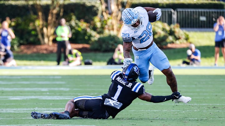 Sep 28, 2024; Durham, North Carolina, USA; Duke Blue Devils safety Terry Moore (1) tackles North Carolina Tar Heels running back Omarion Hampton (28) with the ball during the first half of the game against at Wallace Wade Stadium. Mandatory Credit: Jaylynn Nash-Imagn Images