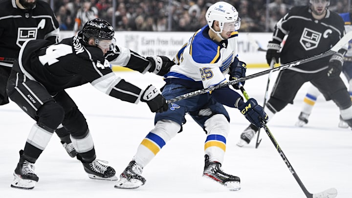 Mar 4, 2023; Los Angeles, California, USA;St. Louis Blues center Jordan Kyrou (25) moves the puck while pressured by Los Angeles Kings defenseman Mikey Anderson (44) during the third period at Crypto.com Arena. The Kings won 3-2. Mandatory Credit: Kelvin Kuo-Imagn Images