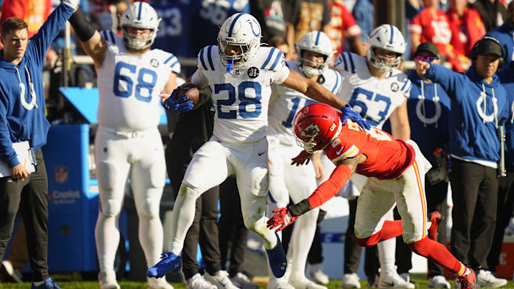 Nov 23, 2025; Kansas City, Missouri, USA;  Indianapolis Colts running back Jonathan Taylor (28) runs against Kansas City Chiefs safety Bryan Cook (6) in the second half at GEHA Field at Arrowhead Stadium. 