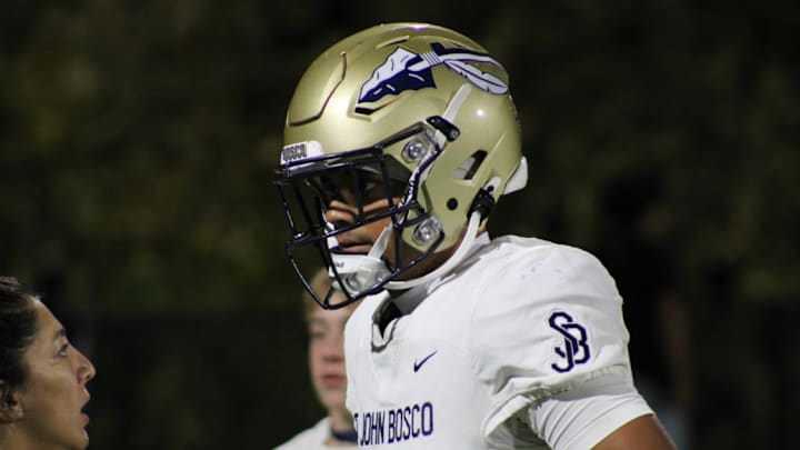 Matai Fuiava of St. John Bosco speaking to the team trainer.