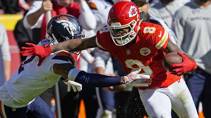 Nov 10, 2024; Kansas City, Missouri, USA; Kansas City Chiefs wide receiver DeAndre Hopkins (8) runs with the ball against Denver Broncos cornerback Pat Surtain II (2) during the first half at GEHA Field at Arrowhead Stadium. 