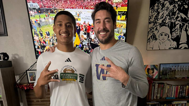 Quarterback Sione Kaho shares a photo moment with JP Losman, former NFL QB and now UW staffer. 