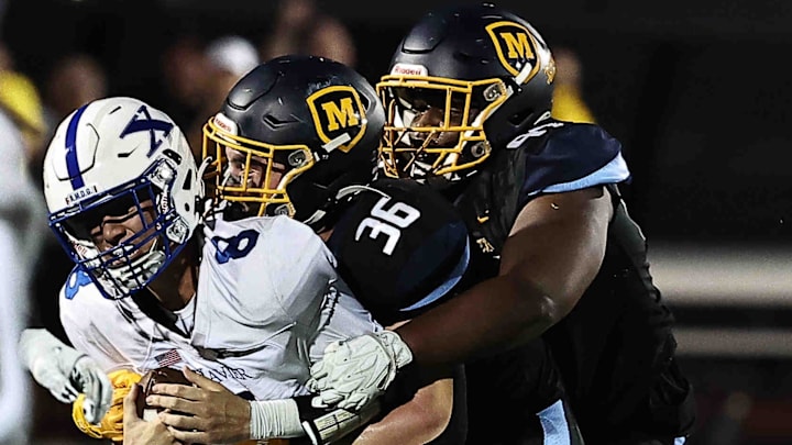 St. Xavier QB is sacked by Archbishop Moeller during their football game Friday, Sept. 19, 2025.