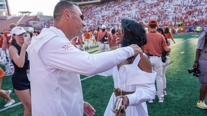 Texas Longhorns head coach Steve Sarkisian hugs and kisses his wife Loreal Sarkisian after the NCAA college football game.