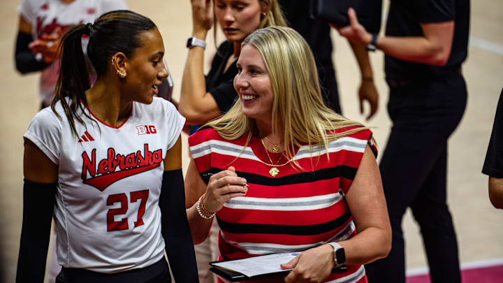 Harper Murray (left) and Dani Busboom Kelly chat before the start of the second set. 