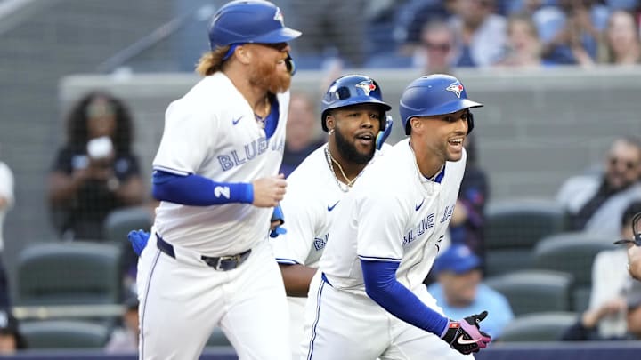 Jun 27, 2024; Toronto, Ontario, CAN; Toronto Blue Jays right fielder George Springer (right), designated hitter Justin Turner (2) and first baseman Vladimir Guerrero Jr. (center) celebrate at home plate after they scored on Springer's home run against the New York Yankees during the first inning at Rogers Centre. Mandatory Credit: John E. Sokolowski-USA TODAY Sports
